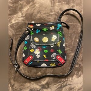 Kathy Van Zeeland black canvas multicolor crossbody with charm accents.